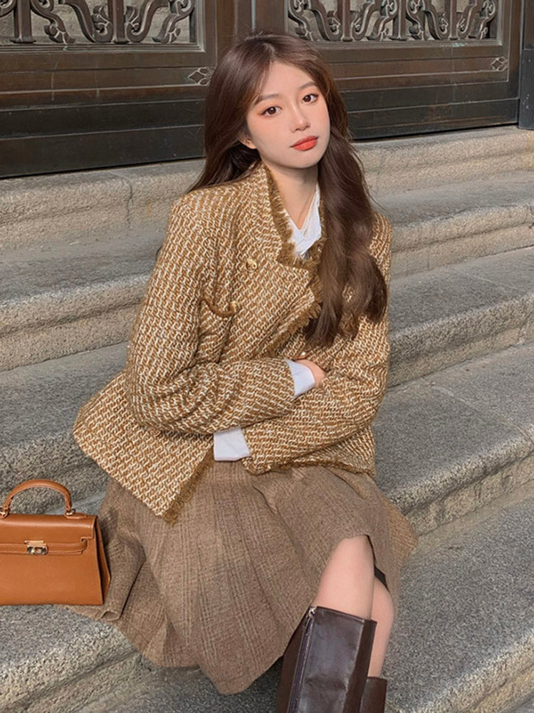 Tweed woolen jacket with gold buttons and a ruffled collar; pleated skirt