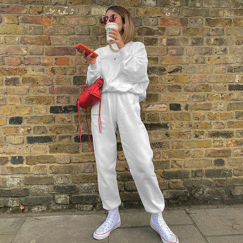 White loose jogger pants with tapered legs and elastic ankle cuffs